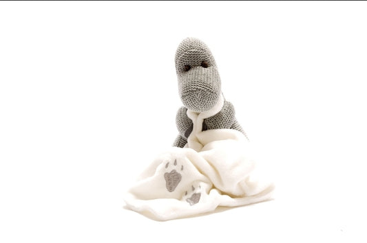 Knitted grey diplodocus dinosaur comforter